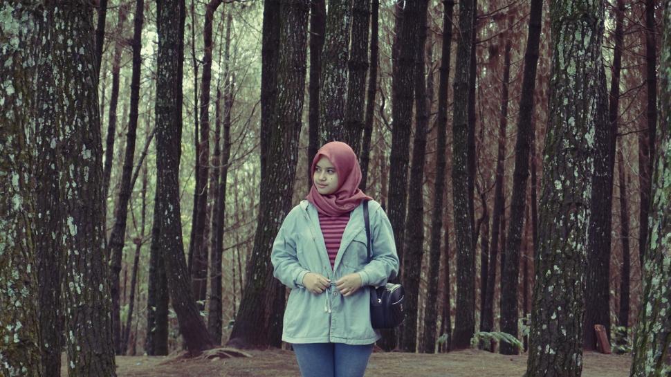 Free Image of Woman in Hijab with trees in the background  