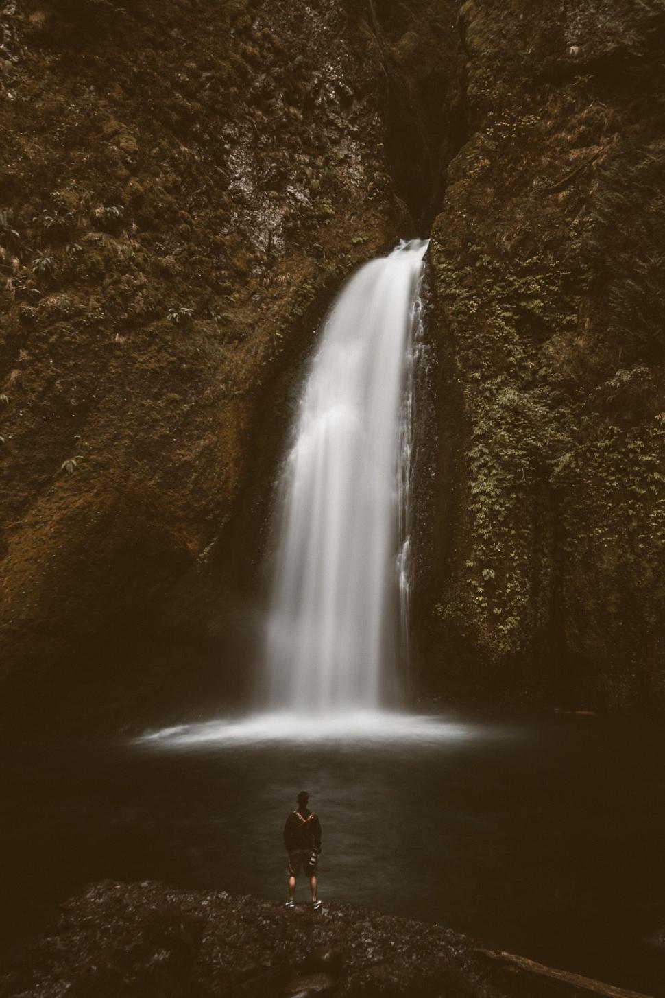 Free Image of Man looking at rock waterfall  