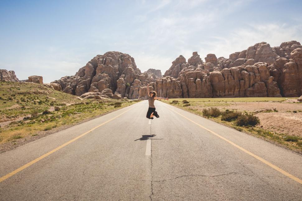 Free Image of Woman Jumping on Road  
