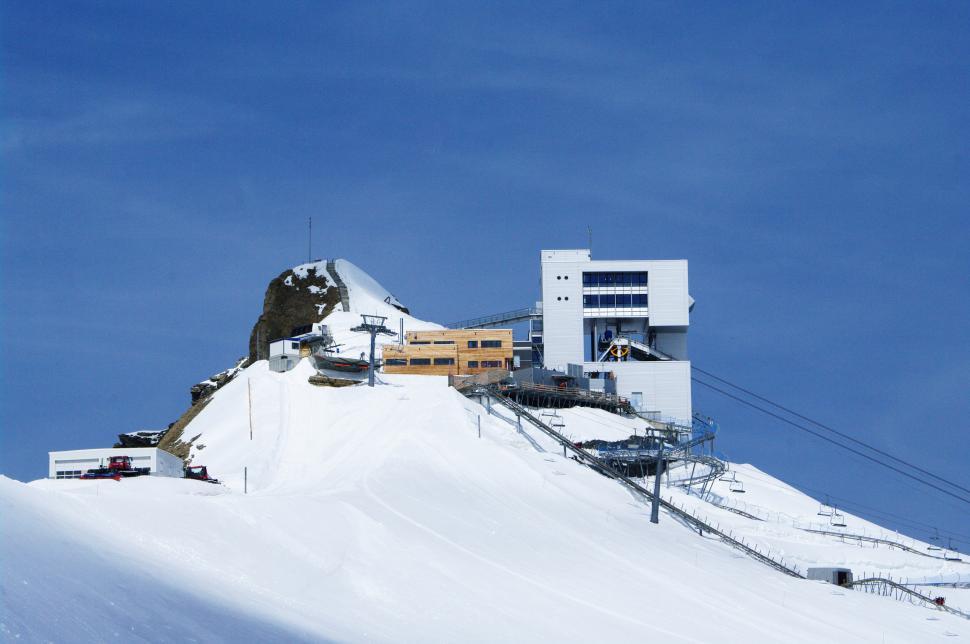 Free Image of Snow Covered Mountain With Building on Top 