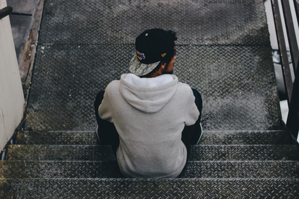 Free Image of Young man sitting on stairs  