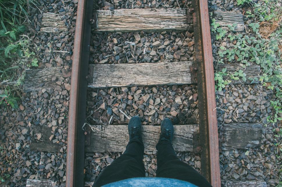 Free Image of Feet on Rail Track  