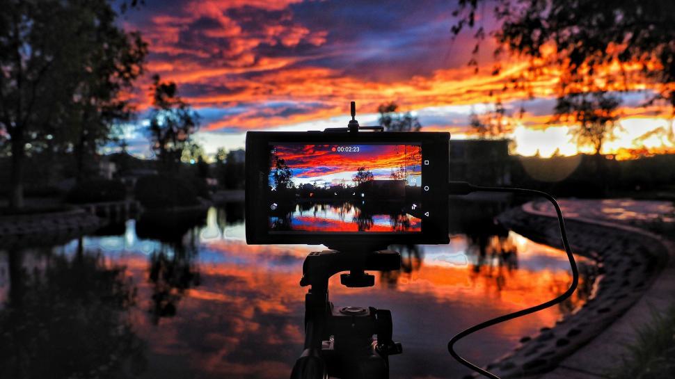 Free Image of Taking Picture of Colorful Sunset  