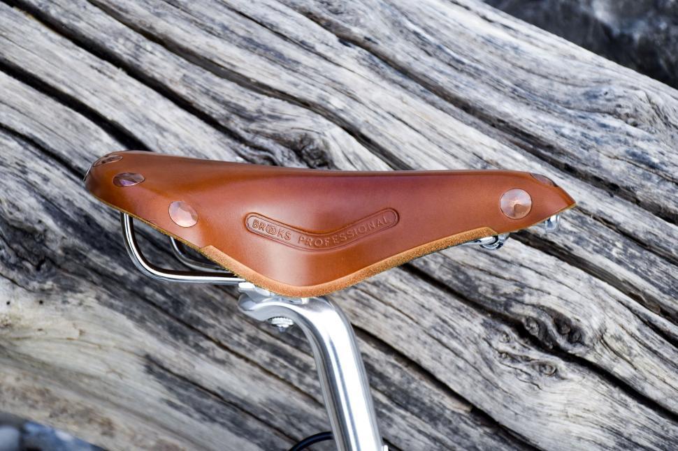 Free Image of Leather Bicycle saddle and tree trunk  