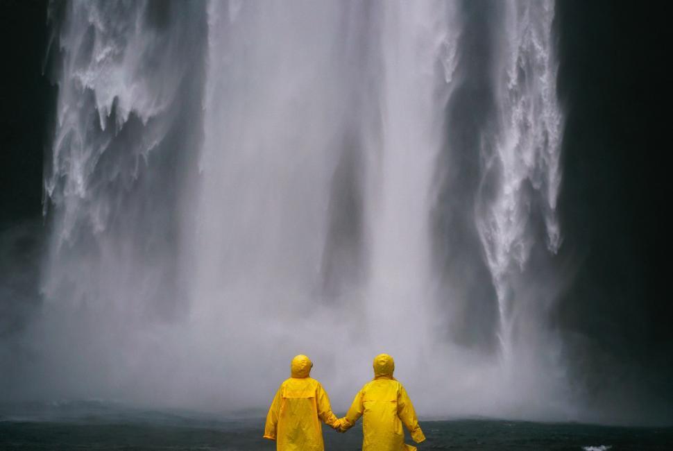 Free Image of Couple in Raincoat Holding Hands  