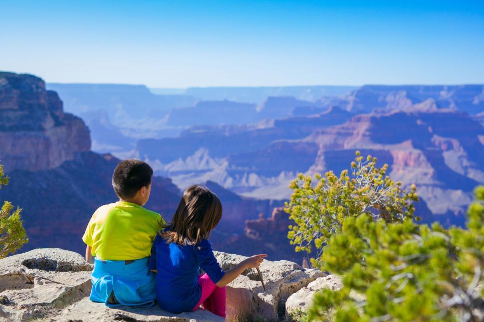 Free Image of Two Children Sitting on Cliff  