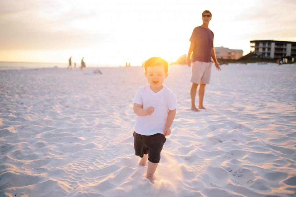 Free Image of Child walking on White Sand beach 
