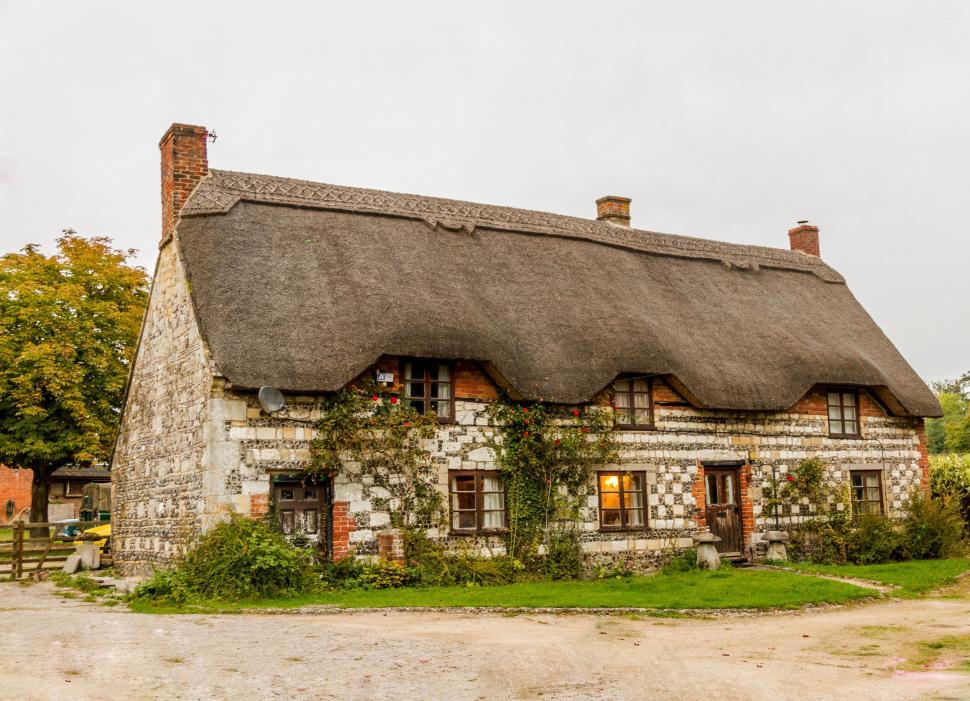 Free Image of Exterior view of thatched roof house 