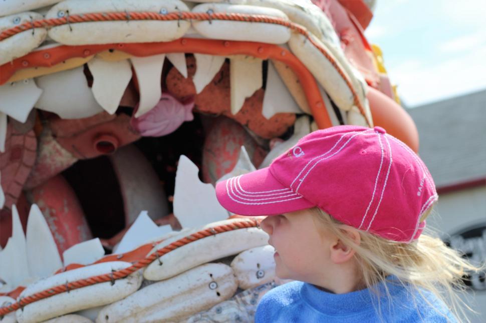 Free Image of Monster Fish Sculpture and Little Girl  