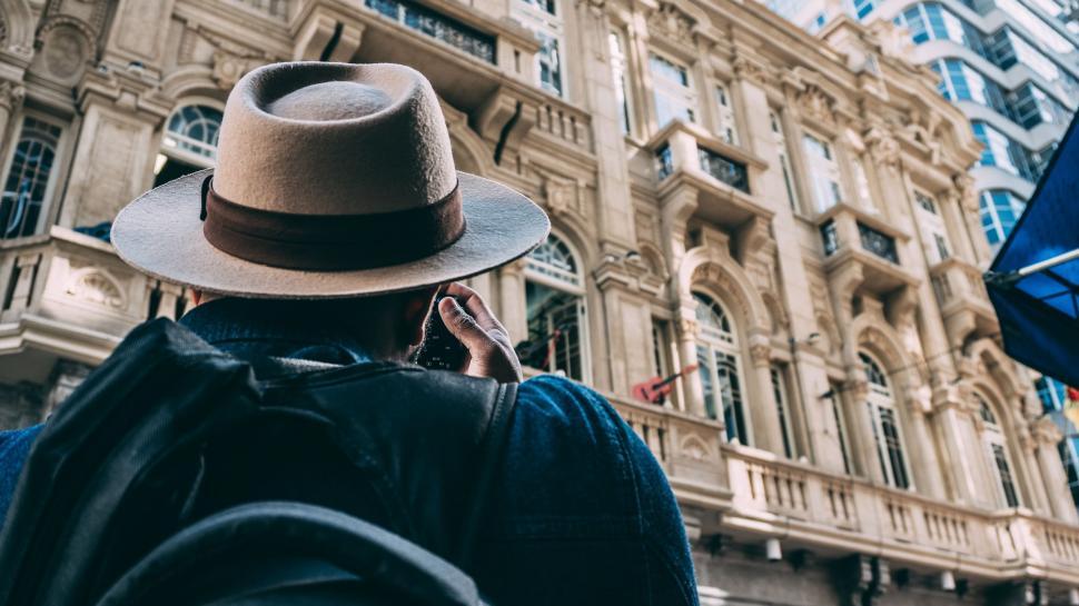 Free Image of Photographer in Brown Hat  