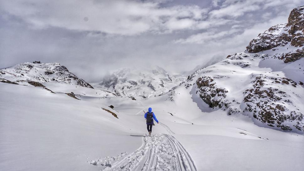 Free Image of Mountaineer walking on Snow  