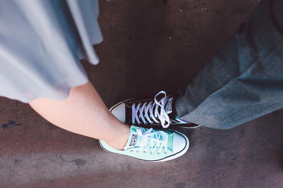 Free Image of Man and Woman Feet in Sneakers  