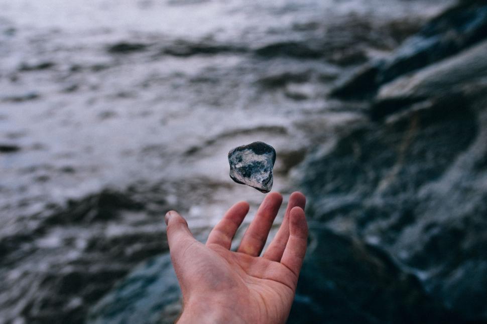 Free Image of Rock, Hand and Ocean   