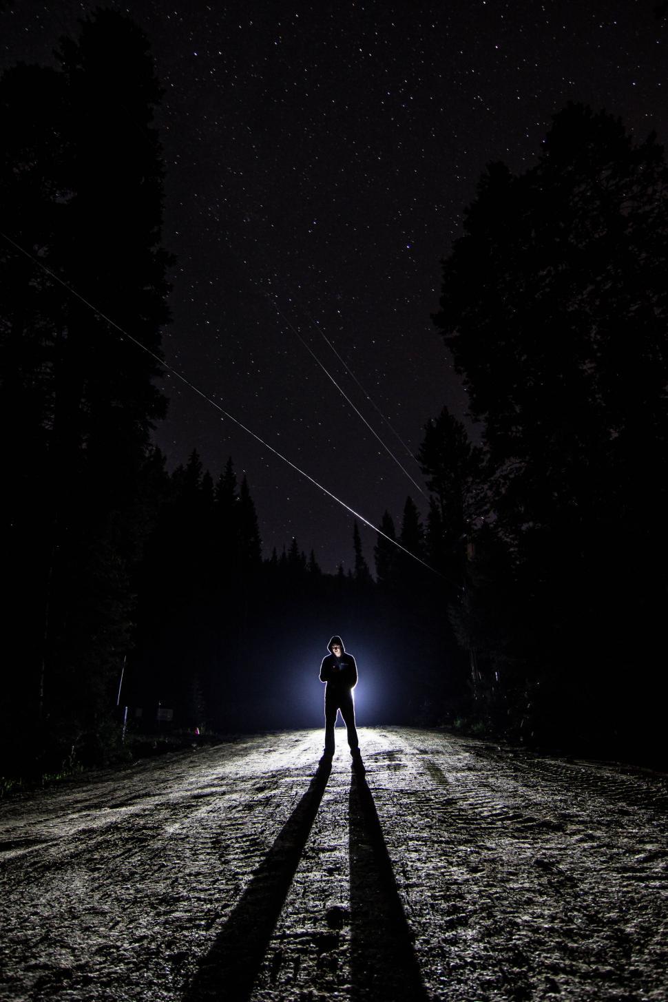 Download Free Stock Photo of Man Standing Alone at Night with stars in the background  
