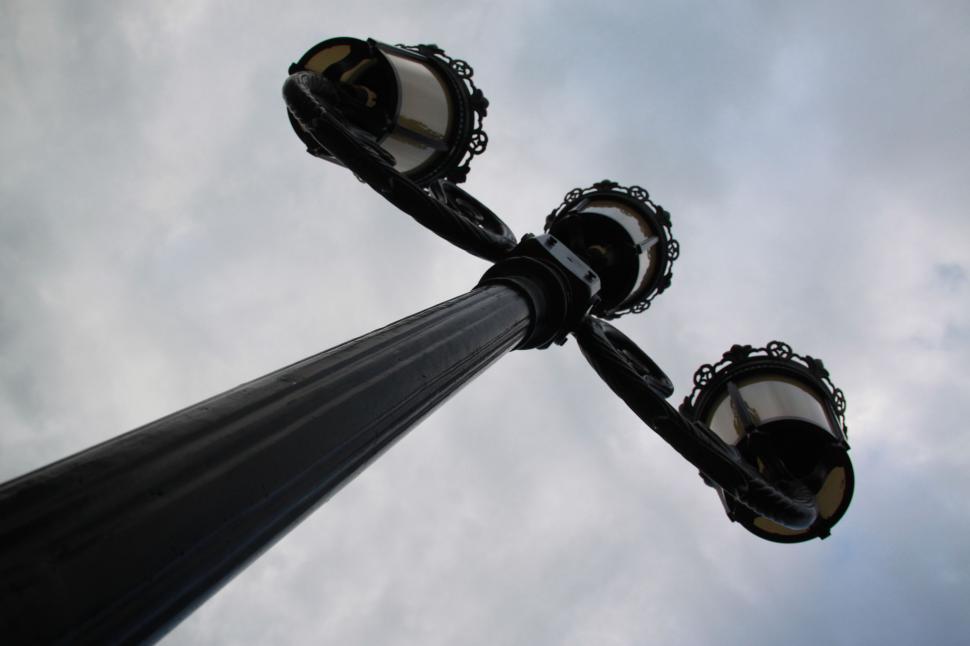 Free Image of Day view of Metal Lamp Post with Three bulbs  