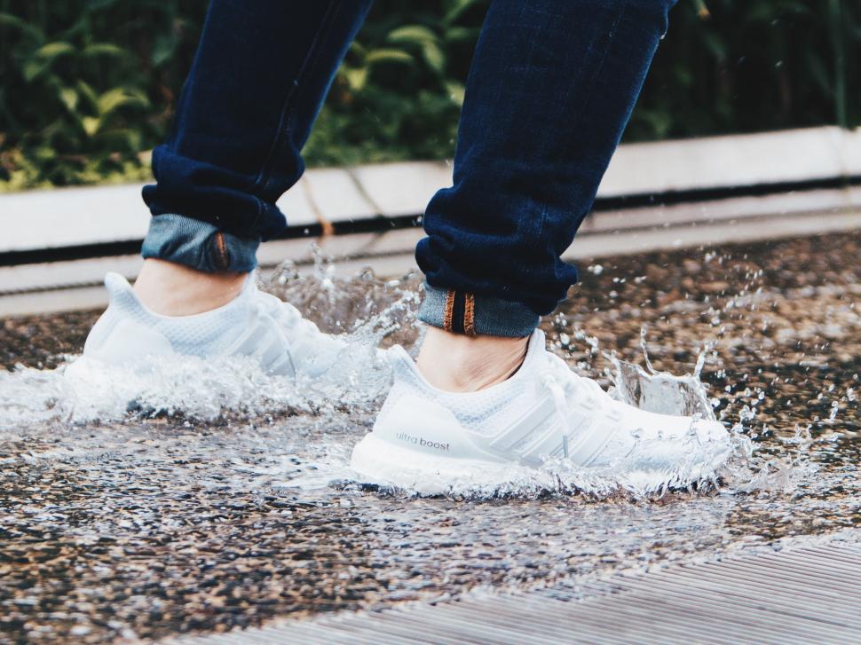 Free Image of White Sneakers in Water  