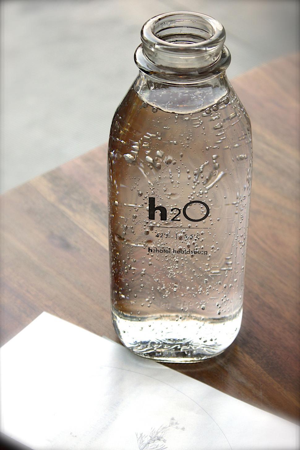 Free Image of h2O Water Bottle on Wooden Table  