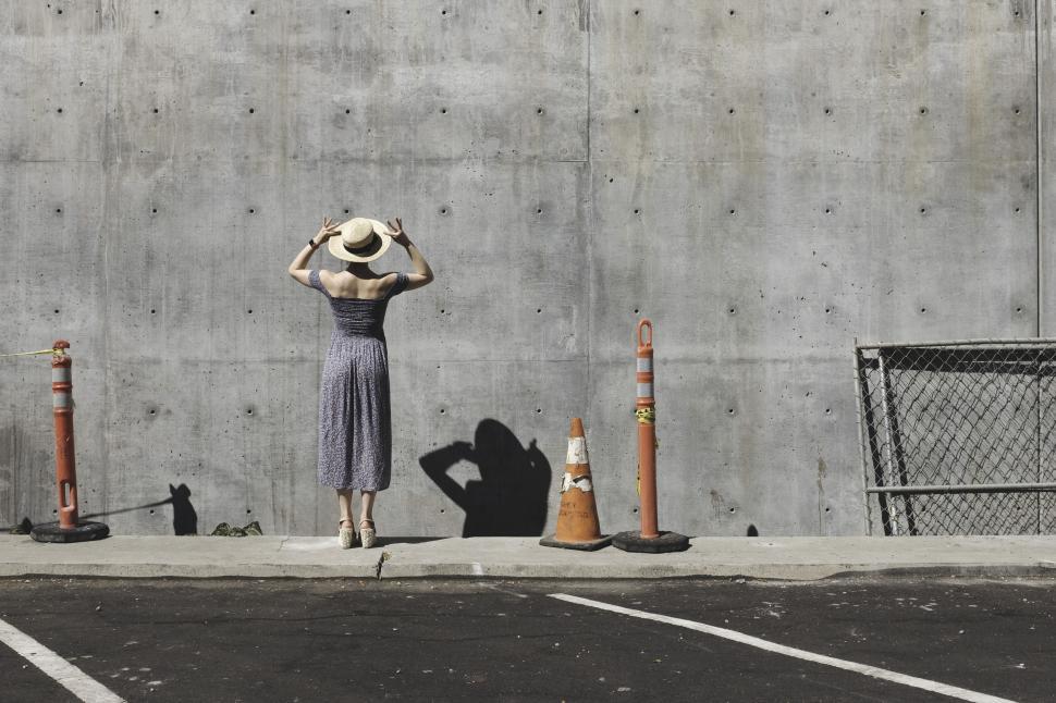 Free Image of Woman in Hat with Traffic Cones  