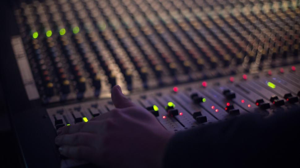 Free Image of Hand using sound mixing console panel  