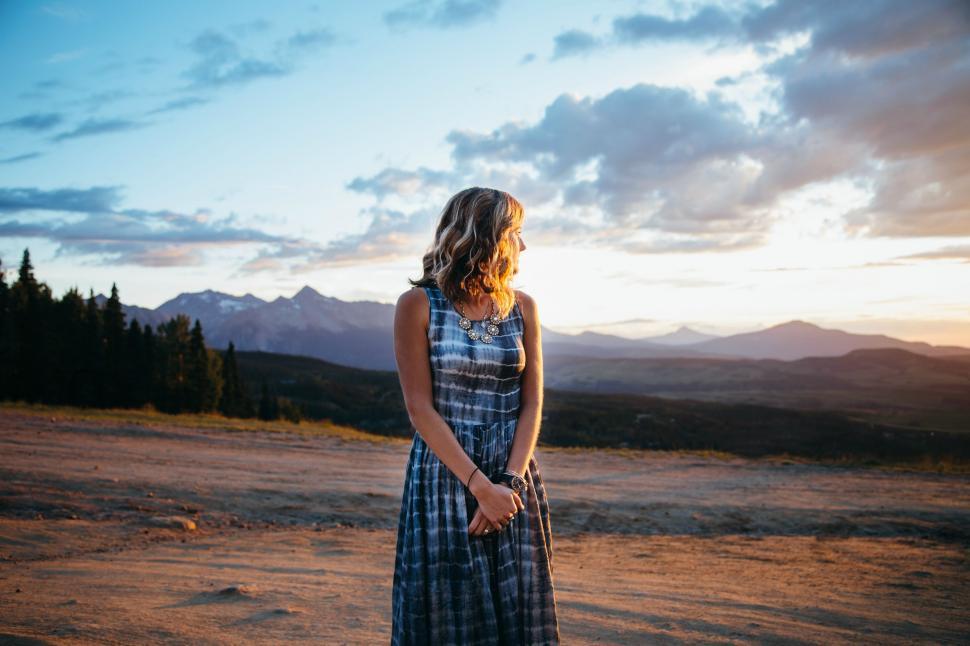 Free Image of Young Blonde Woman looking away at mountain range  