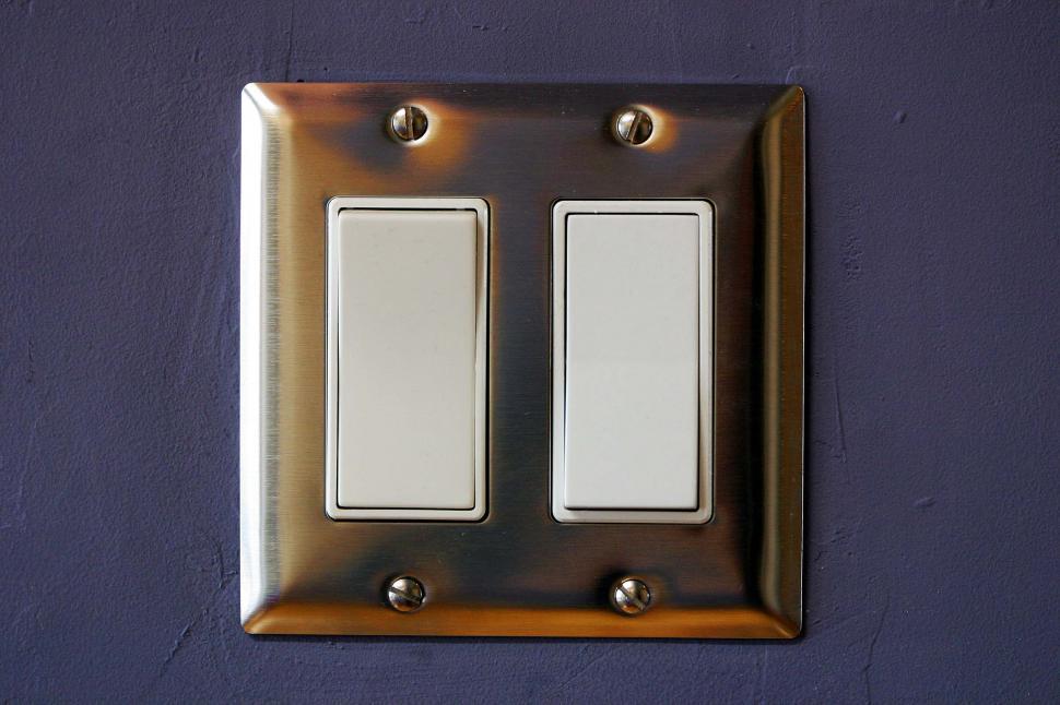 Free Image of Light switches and chrome switchplate 