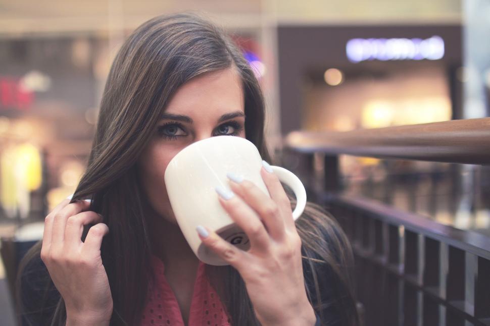 Free Image of Woman Drinking Coffee - Eye Contact  