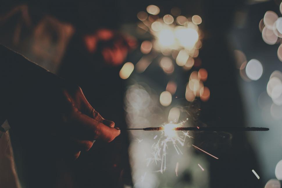 Free Image of Sparkler with Bokeh Lights  