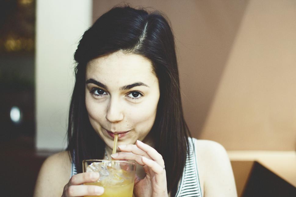 Free Image of Woman Drinking with Straw  