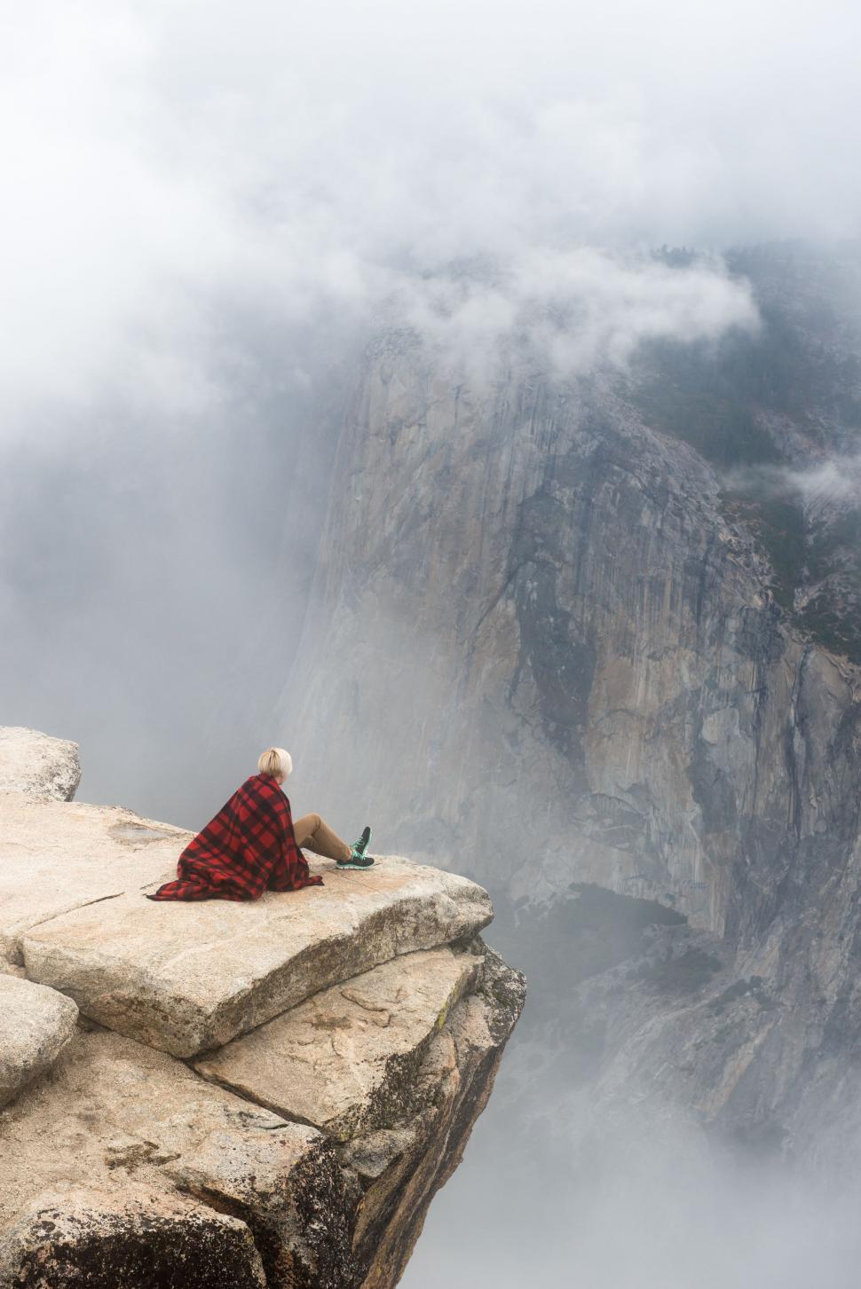 Free Image of Lonely Man On Top Mountain with Clouds  