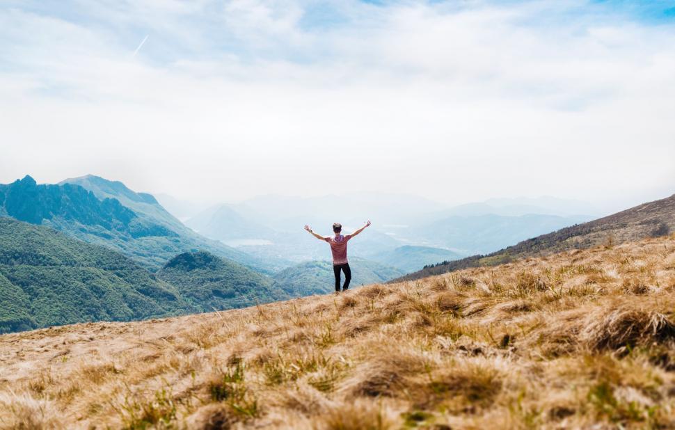 Free Image of Man on Mountain with Open Arms  