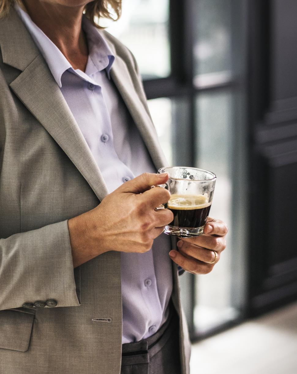 Free Image of Close up of a a businesswoman holding a small coffee 
