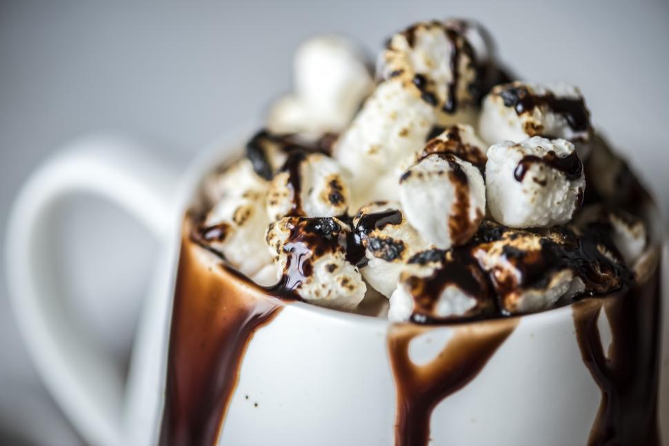 Free Image of Overflowing hot chocolate with marshmallows and chocolate sauce 