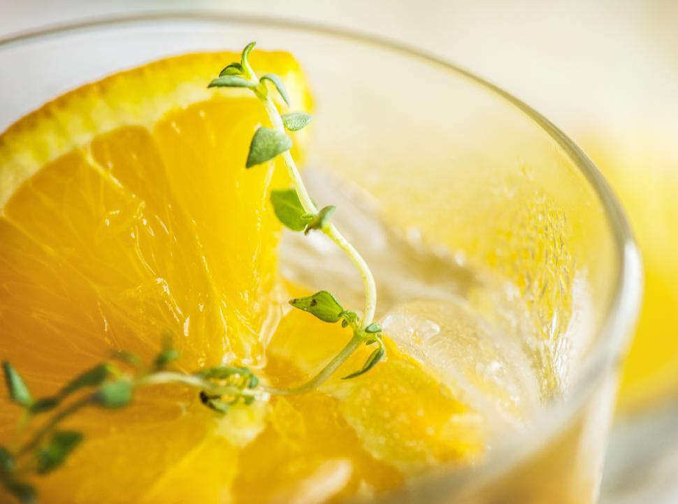 Free Image of Close up of chilled beverage in a glass garnished with orange slices 