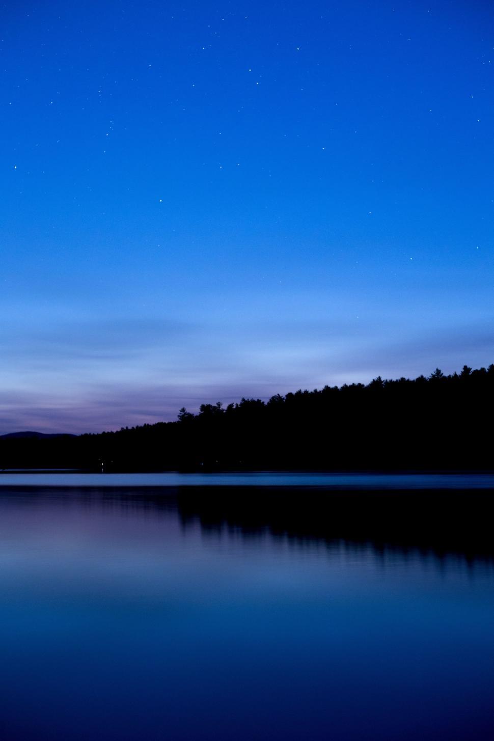Free Image of Silhouette of trees on blue lake 