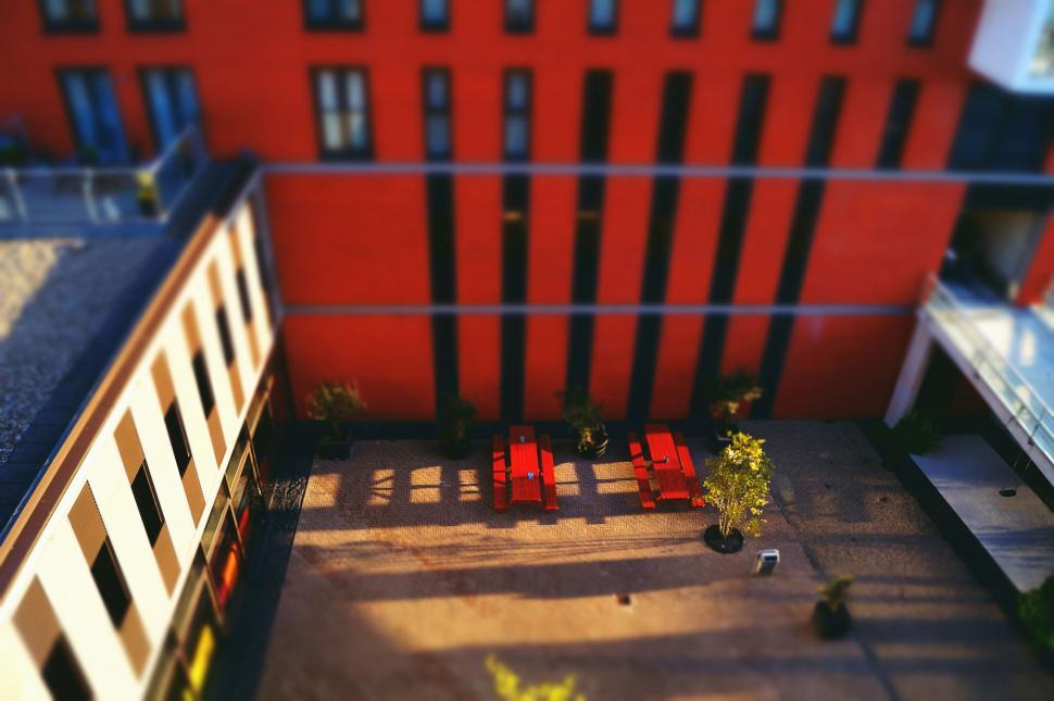 Free Image of Red Benches and Building from Above  