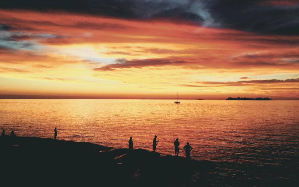 Free Image of People Fishing in Lake During Sunset  
