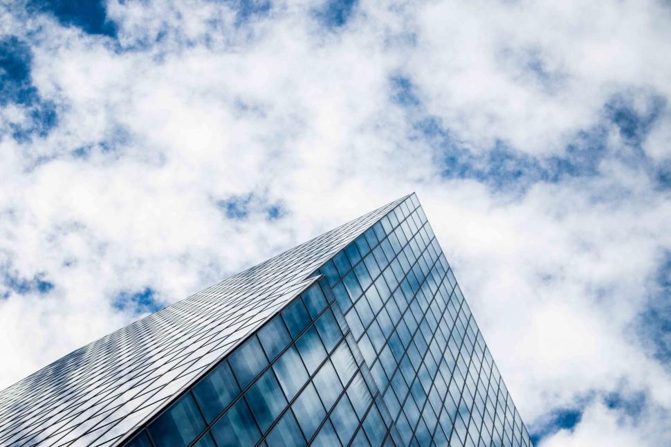 Free Image of White Clouds and Skyscraper  
