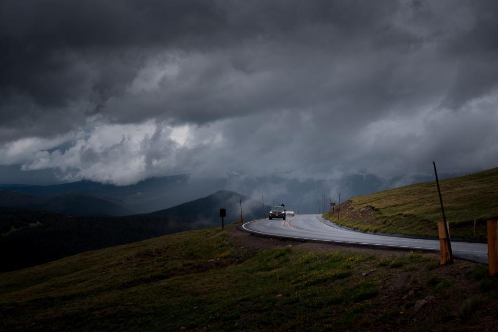 Free Image of Dark Clouds over mountain road  