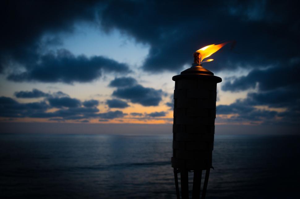 Free Image of Tiki torch with dark evening sky  