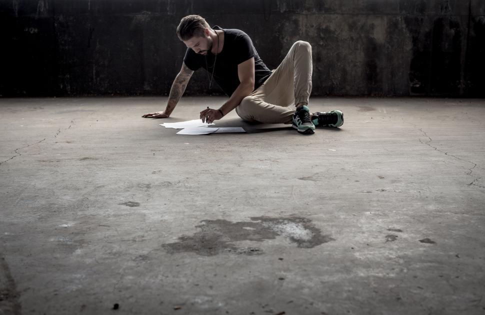 Free Image of Man reading on ground - copy space  