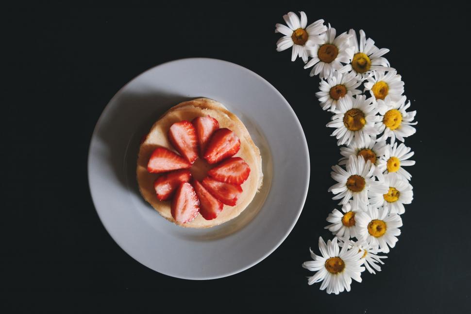 Free Image of White Flowers and Strawberries on black background 