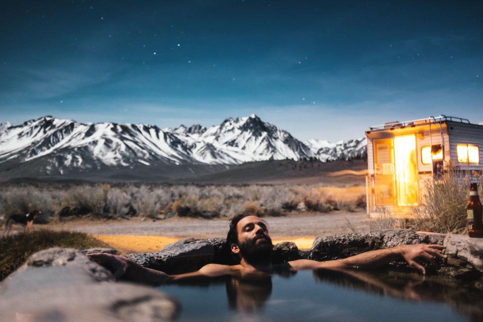 Free Image of Man in hot spring pool in the mountains 