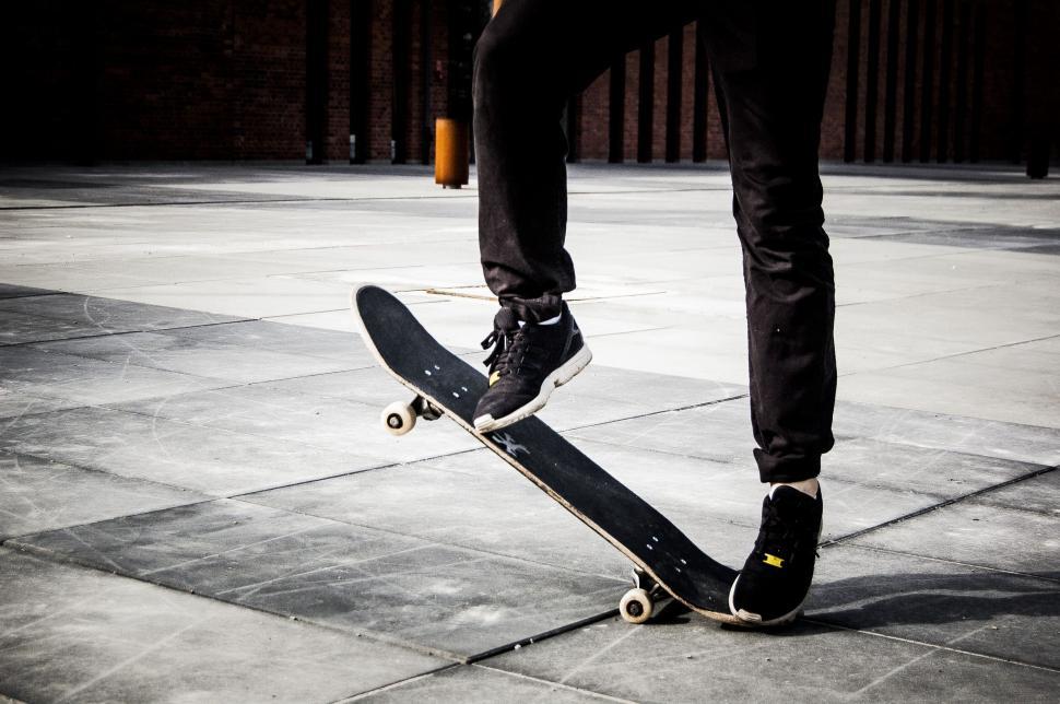 Free Image of Skateboard trick with legs (Ollie) 