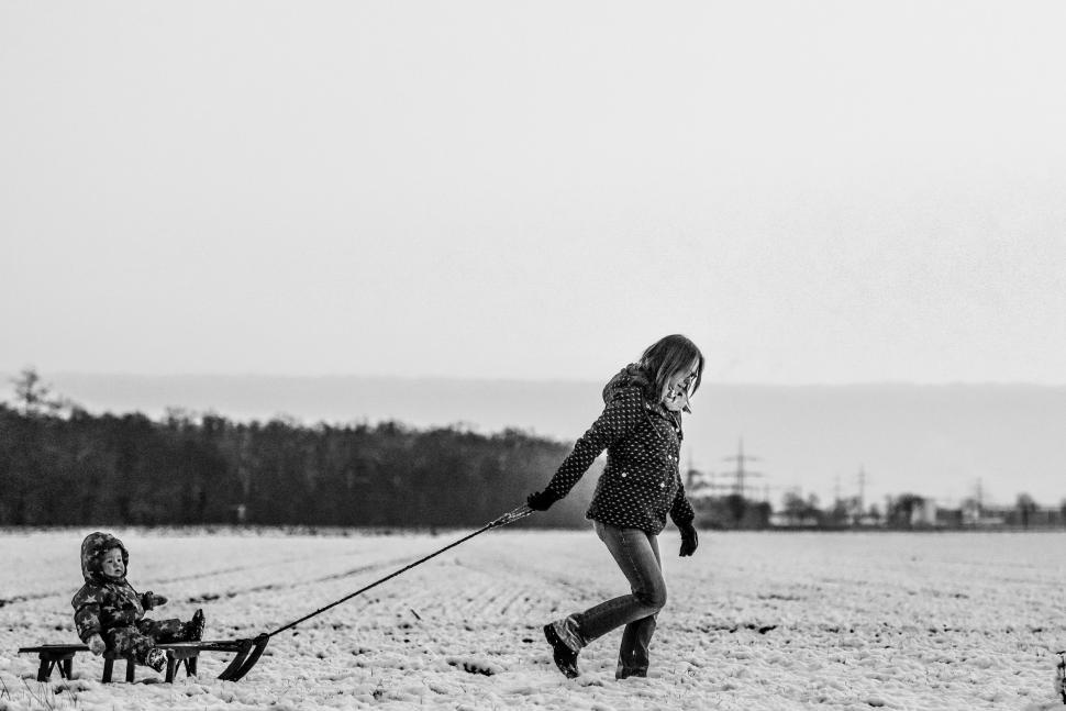 Free Image of Mother and Daughter playing in the snow 