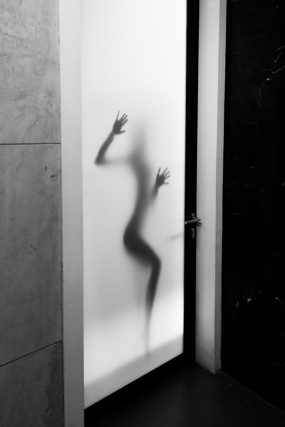 Free Image of Woman hands behind glass door  