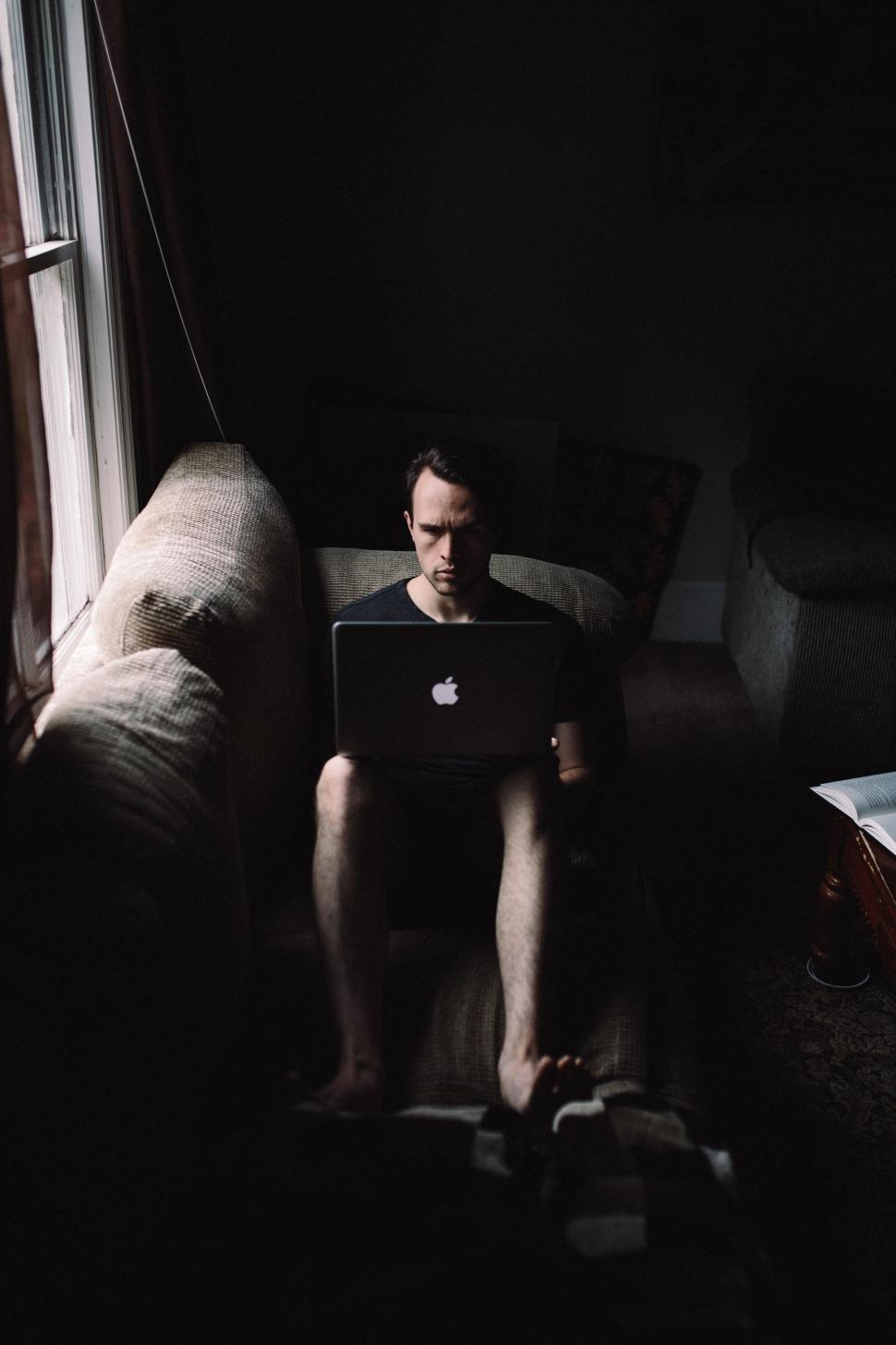 Free Image of Man using laptop in home  