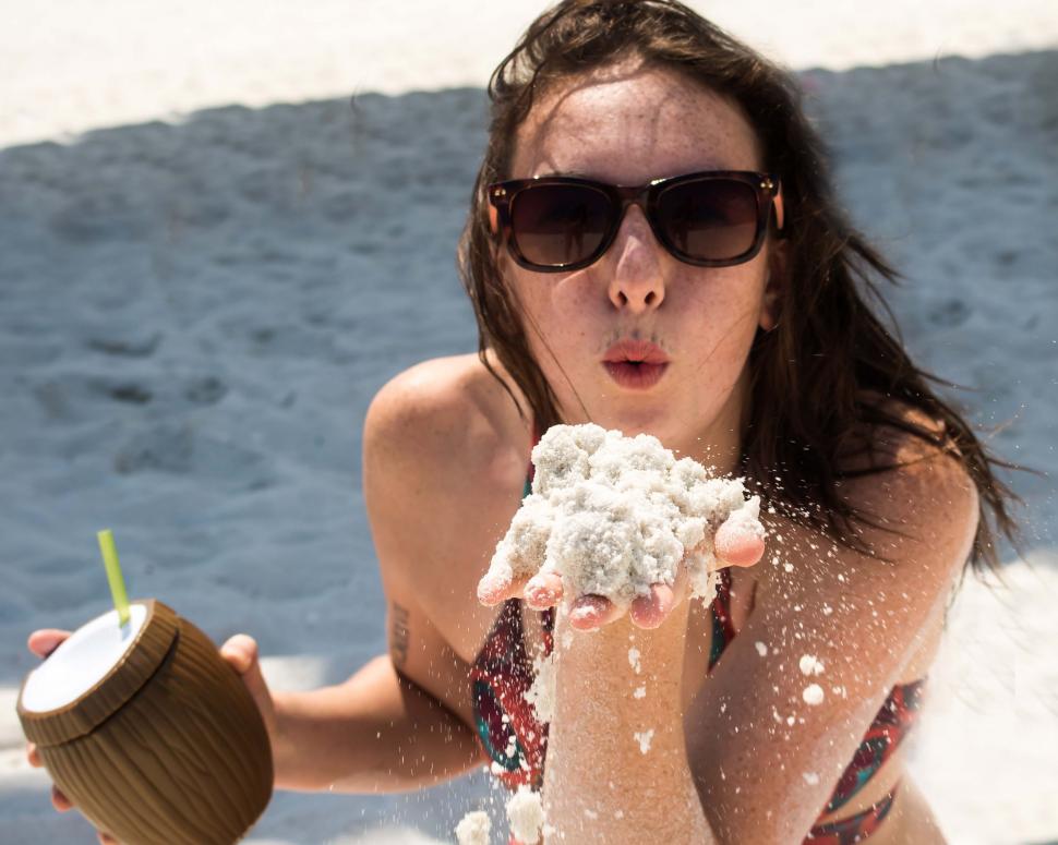 Free Image of Woman playing with sand - eye contact  