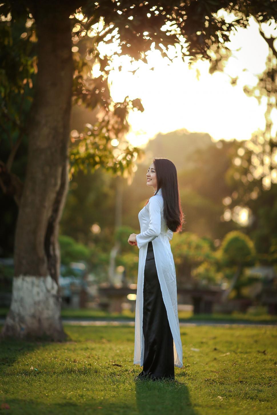Free Image of Vietnamese Woman Standing on Green Grass 