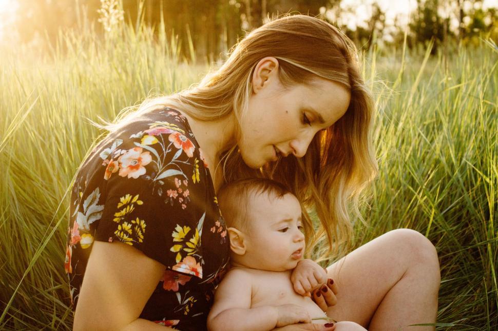 Free Image of Woman with Child in Grass Field  