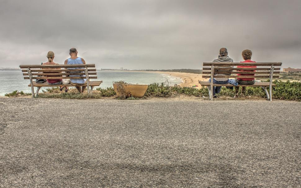 Free Image of Pair of Couples on Benches at seashore 